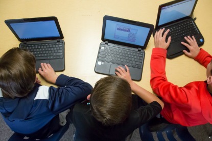 image: laptops with students