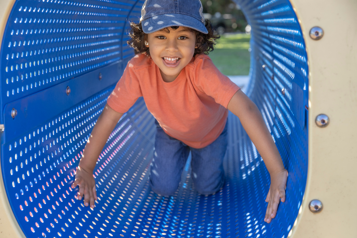 Preschooler on the playground, smiling