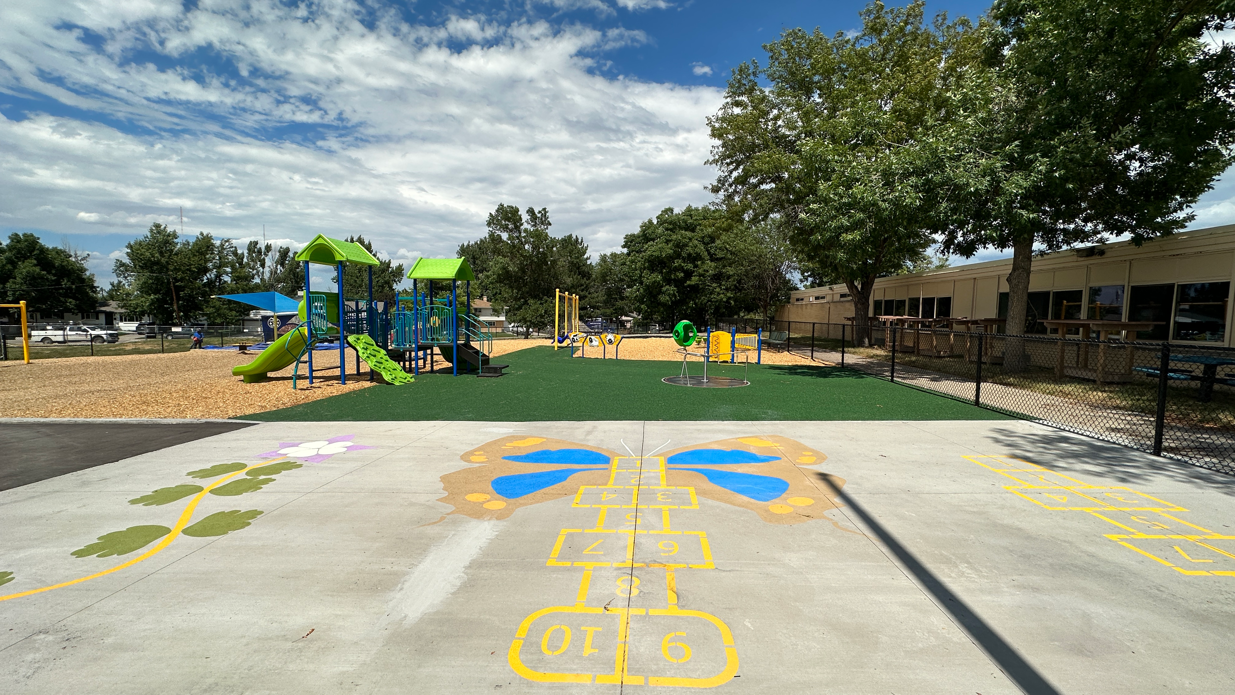 Wide shot of the playground at The Village including hopscotch and jungle gym