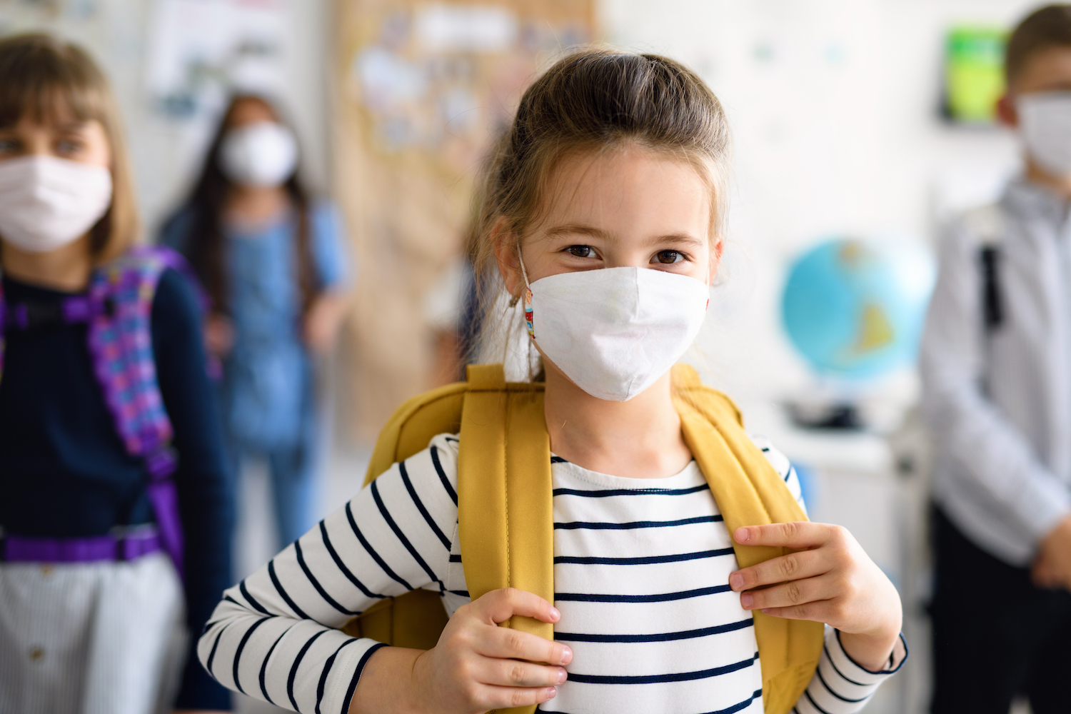 Girl in Mask in School Hallway