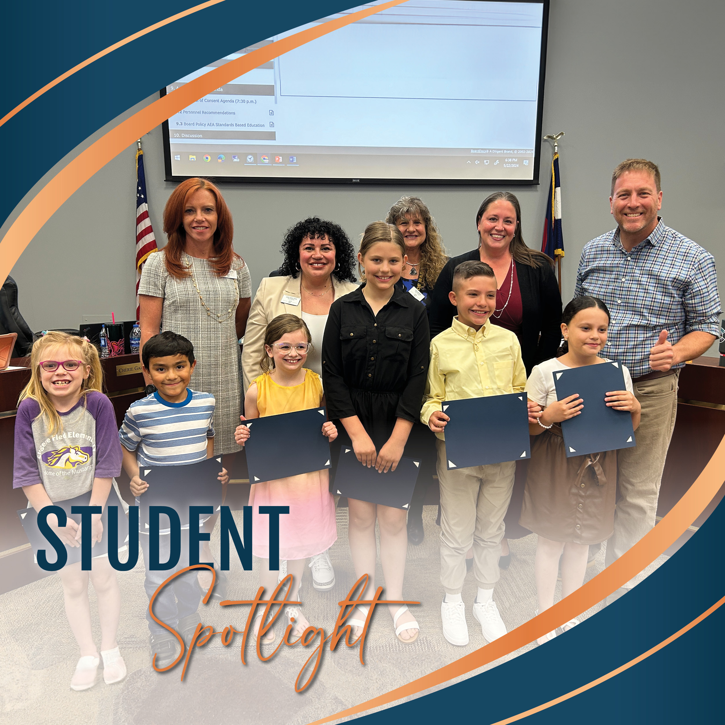 Field Elementary Student Spotlight recipients holding their certificates with the Board of Education in front of the Board dais