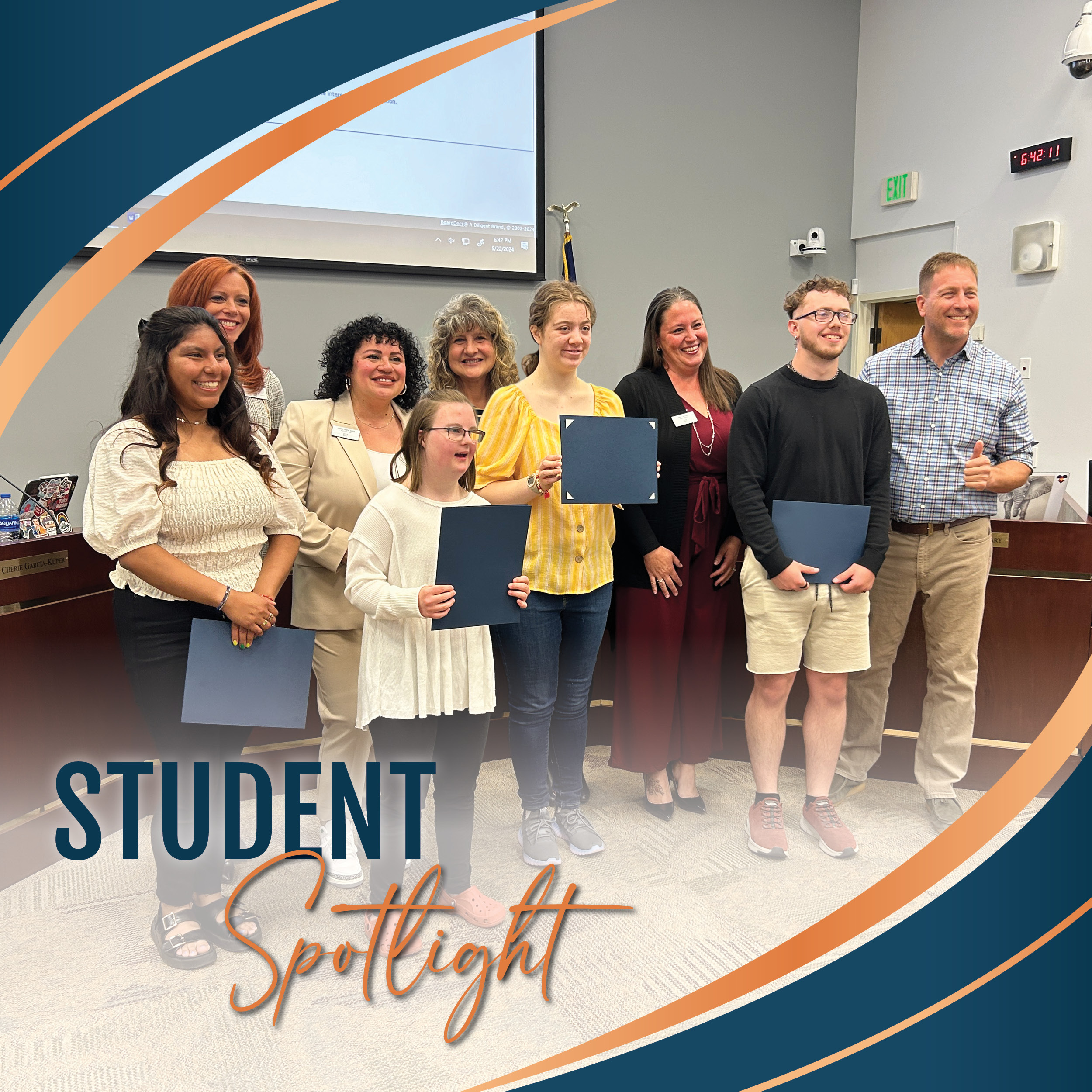 Transition Services Student Spotlight recipients holding their certificates with the Board of Education in front of the Board dais