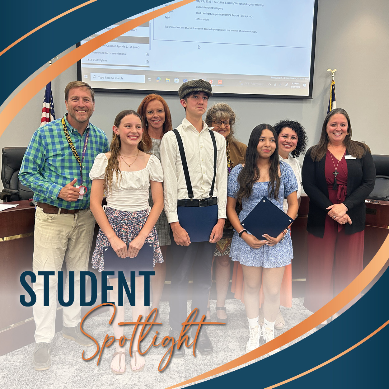 Eight people, including three students from Littleton Preparatory Charter School, pose together in a formal setting at a Board of Education meeting. The students, two girls and one boy, are dressed nicely and hold award folders. Behind them stand five smiling board members. The background features a large screen with meeting details and an American flag. A graphic overlay at the bottom reads “Student Spotlight” in bold navy and script-style orange lettering, framed by curved bands in LPS brand colors—deep navy, slate blue, and burnt orange.